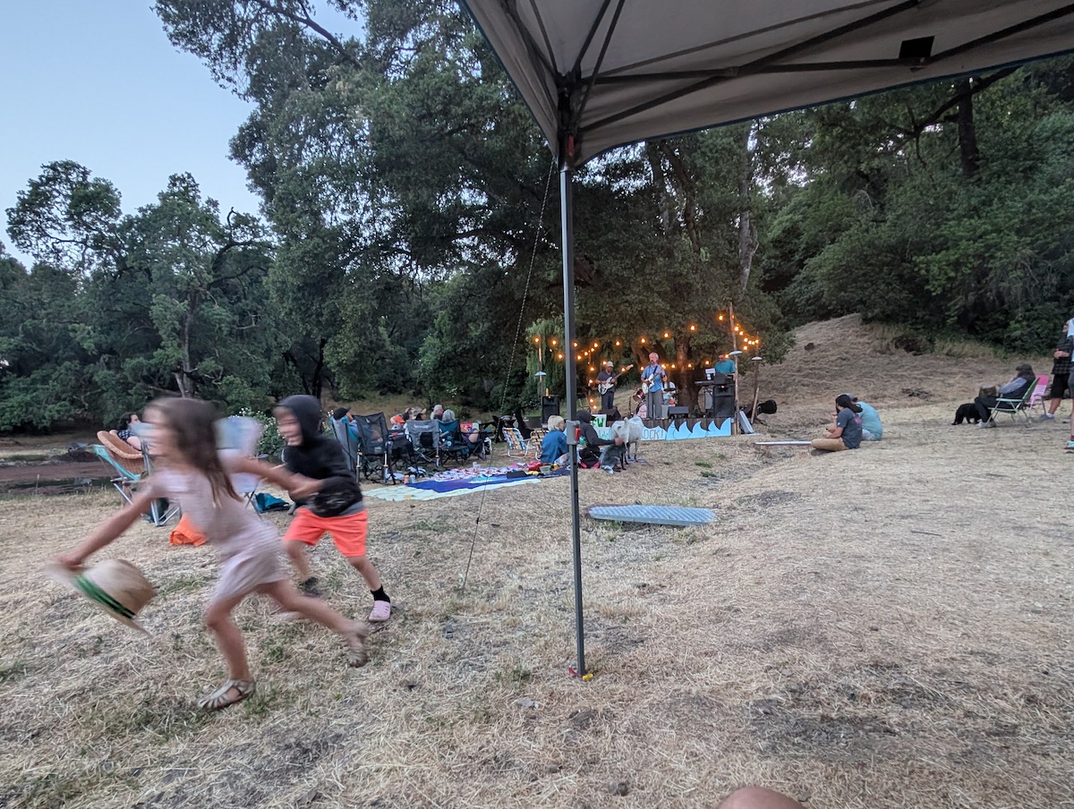 Kids playing while the bands play